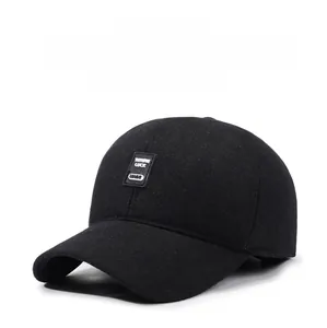Detailed view of black wool baseball cap featuring a decorative branded patch on the front