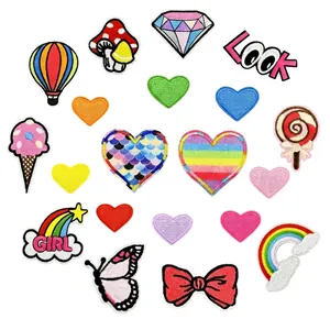 Close-up of vibrant embroidery patches featuring colorful hearts, rainbows, and icons
