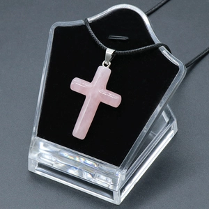 Pink natural crystal cross pendant necklace with black woven rope on display stand