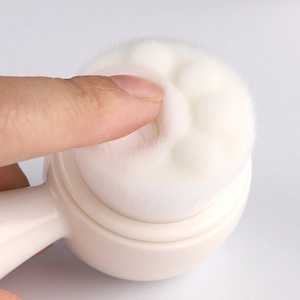Macro shot of soft fiber bristles on the cat claw facial brush showing high density