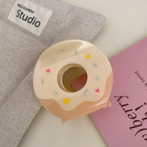 Detail of creative donut hair claw clip with realistic cream icing and sugar beads texture