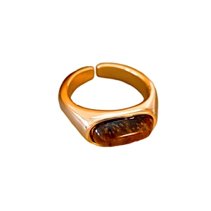 Vintage gold adjustable ring featuring a rectangular tiger eye stone on white background