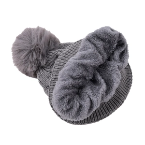 Detail view of the thick gray plush lining and cable knit texture on the warm winter hat