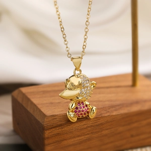 Detailed close-up of gold-plated platypus pendant with rose red and clear zircon stones