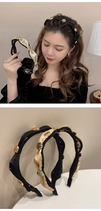 Close-up of twisted velvet headbands in black and beige with golden rose metal charms