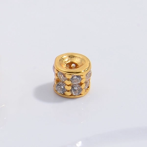 Close-up of gold-plated S925 silver spacer bead with sparkling zircon inlay for DIY jewelry