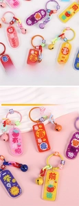 Detailed view of colorful acrylic keychains with lucky charms and vibrant bells