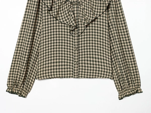 Detailed view of vintage green and yellow plaid shirt with large ruffle collar and buttons