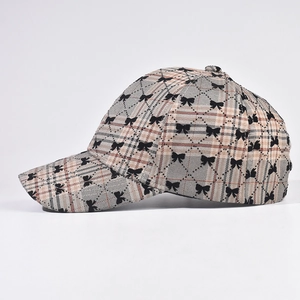Classic khaki plaid baseball cap with black embroidered bows and structured crown