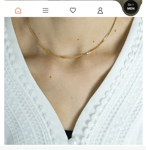 Close-up of dual-layer golden blade chain necklace with cotton pearl on model neck