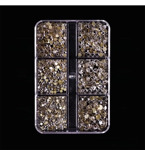 Close-up of 6 sizes of flatback white glass rhinestones with gold base for nail art