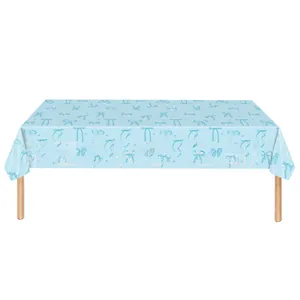 Close-up of light blue disposable tablecloth with bow and star patterns for birthday parties