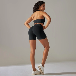 Rear view of charcoal grey seamless yoga set featuring ribbed knit high-waist shorts and vest
