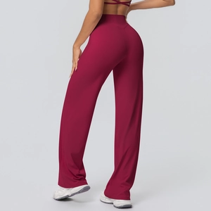 Macro shot of high waist V-shaped seam and drape of wine red flared yoga pants