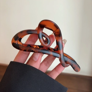 Detail of tortoise shell heart cutout hair claw clip made of premium resin material