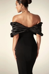 Detail of back zipper and ruched satin design on a black off-shoulder evening dress