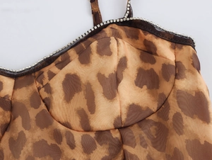 Close-up of leopard print top featuring rhinestone neckline and shaped bust detail