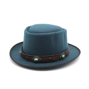 Detail of dark blue felt hat with vintage leather band and turquoise metal studs