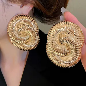 Chic gold spiral textured round earrings with bold geometric shell pattern for women