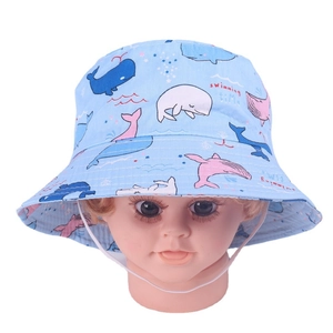 Detail showing baby bucket hat with whale print, light blue fabric, and chin strap