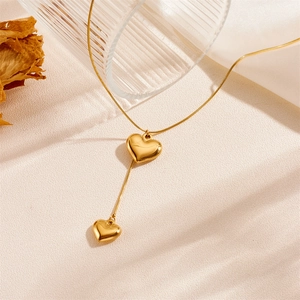 Elegant gold double heart tassel necklace in polished stainless steel for women