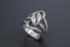 Macro shot of twin snake wrap ring in silver steel with detailed reptile scales