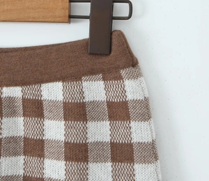Detail view of brown and white checkered knit shorts with high-quality fabric texture
