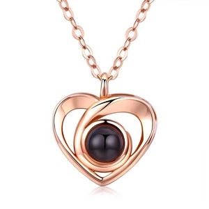 Elegant rose gold heart pendant necklace with projection stone on white background