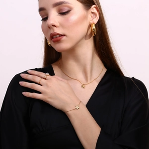 Detail of 18K gold plated flower necklace and matching jewelry set on model