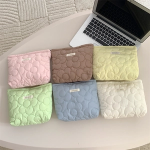 Detailed close-up of quilted floral cosmetic bags in six vibrant pastel color options