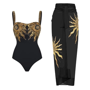 Detail of black swimsuit and sarong with intricate gold sunbeam sequins embroidery