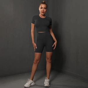 Close-up of charcoal grey seamless yoga set featuring crop top and high waist shorts