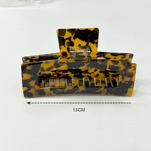 Detail of 13cm large tortoiseshell hair claw clip with brown leopard pattern on white background
