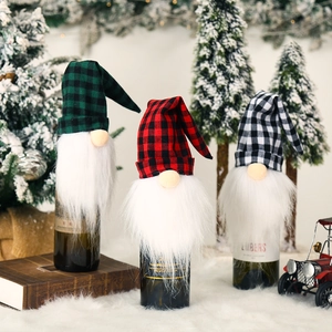 Three festive Christmas gnome wine bottle covers in assorted plaid patterns for holiday decor