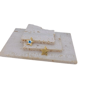 Gold plated star shell charm with evil eye zircon on minimalist travertine stones