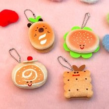 Detailed view of handmade plush cat charms in assorted burger and dessert food shapes
