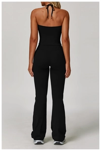 Detail of black halter backless top and flared yoga pants with high-waist fit