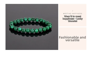 Detail of 8mm green malachite bead bracelet with dark textures on black mirror surface