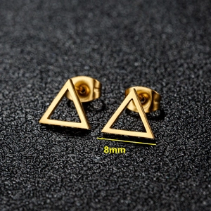 Golden 8mm geometric triangle stud earrings in stainless steel on black surface