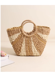 Detailed weave of beige and brown straw tote with gold thread and circular handles