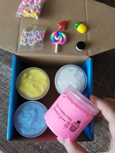 Macro shot of colorful butter slime jars with DIY charms and sprinkles for kids