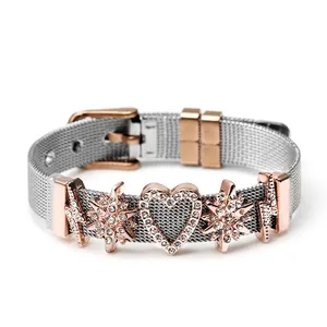 Detail of Milanese mesh bracelet with heart pendant and star charms in two-tone finish