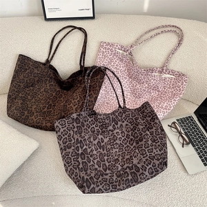 Three leopard print tote bags in pink, brown, and grey shown with stylish outer pockets