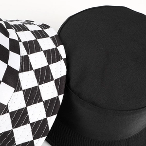 Reversible checkerboard print bucket hat with minimalist black flat top design