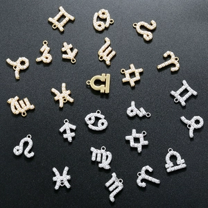 Macro shot of twelve zodiac constellation pendants in gold and silver with pearl accents