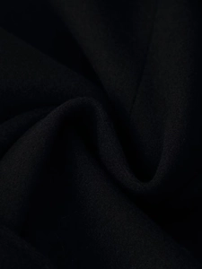 Close-up of premium black wool fabric texture and fiber details on hooded coat