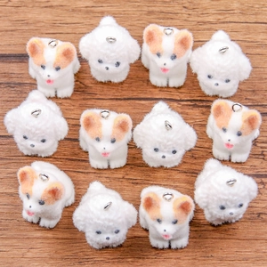 Macro view of 12 flocked dog pendants arranged on a wooden surface with metal rings