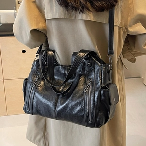Classic black PU leather tote bag with large capacity shown in a stylish outdoor setting