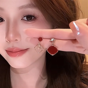 Elegant gold plated silver needle geometric zircon drop earrings worn by a model