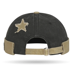 Vintage color-block docker hat with star patch and adjustable strap in washed black and khaki
